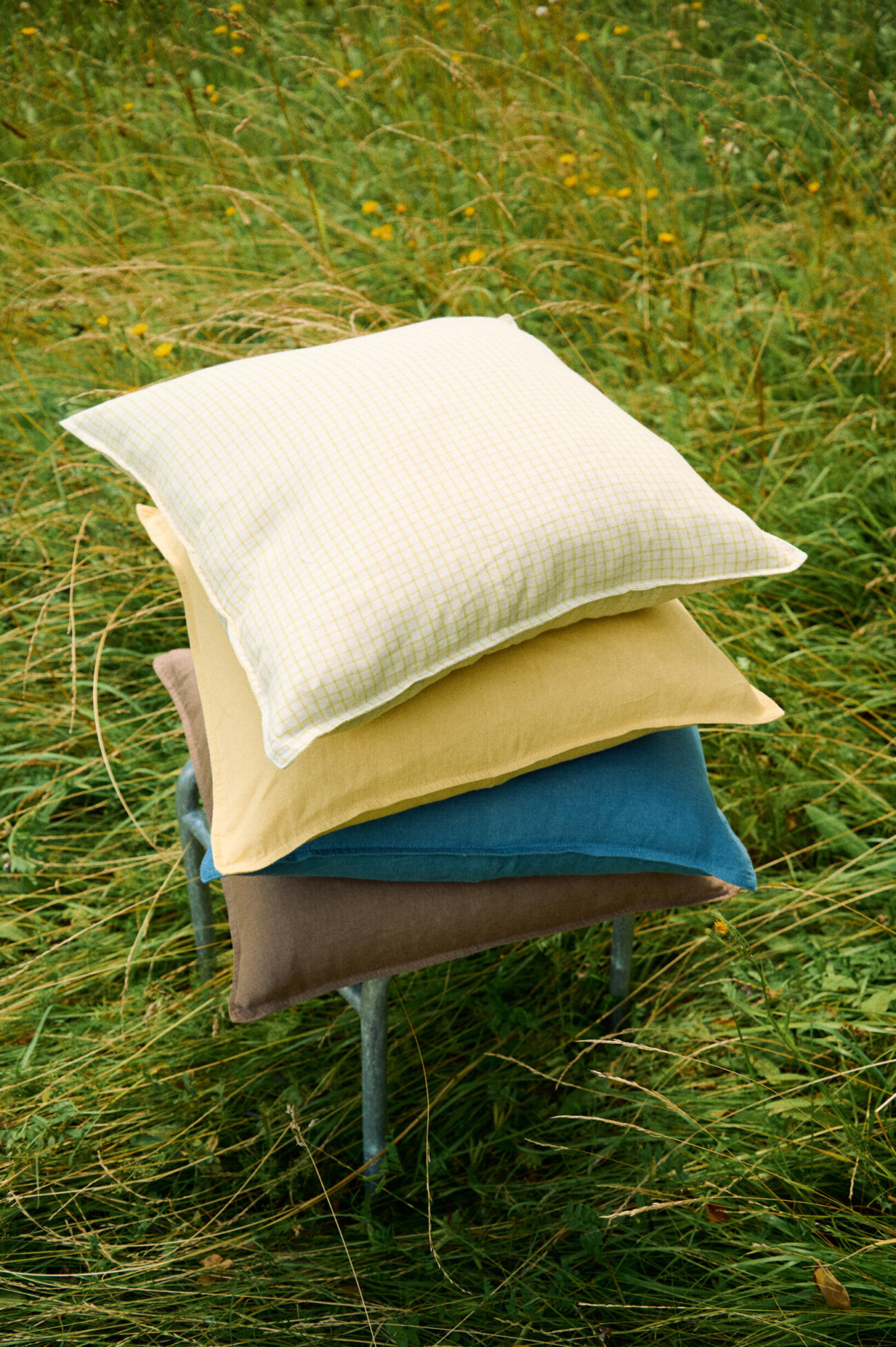 Apple Checks linen pillow cover with a green checkered pattern and stitched border.