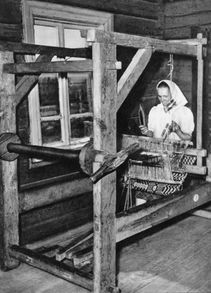 Lithuanian woman weaving linen on a traditional wooden loom